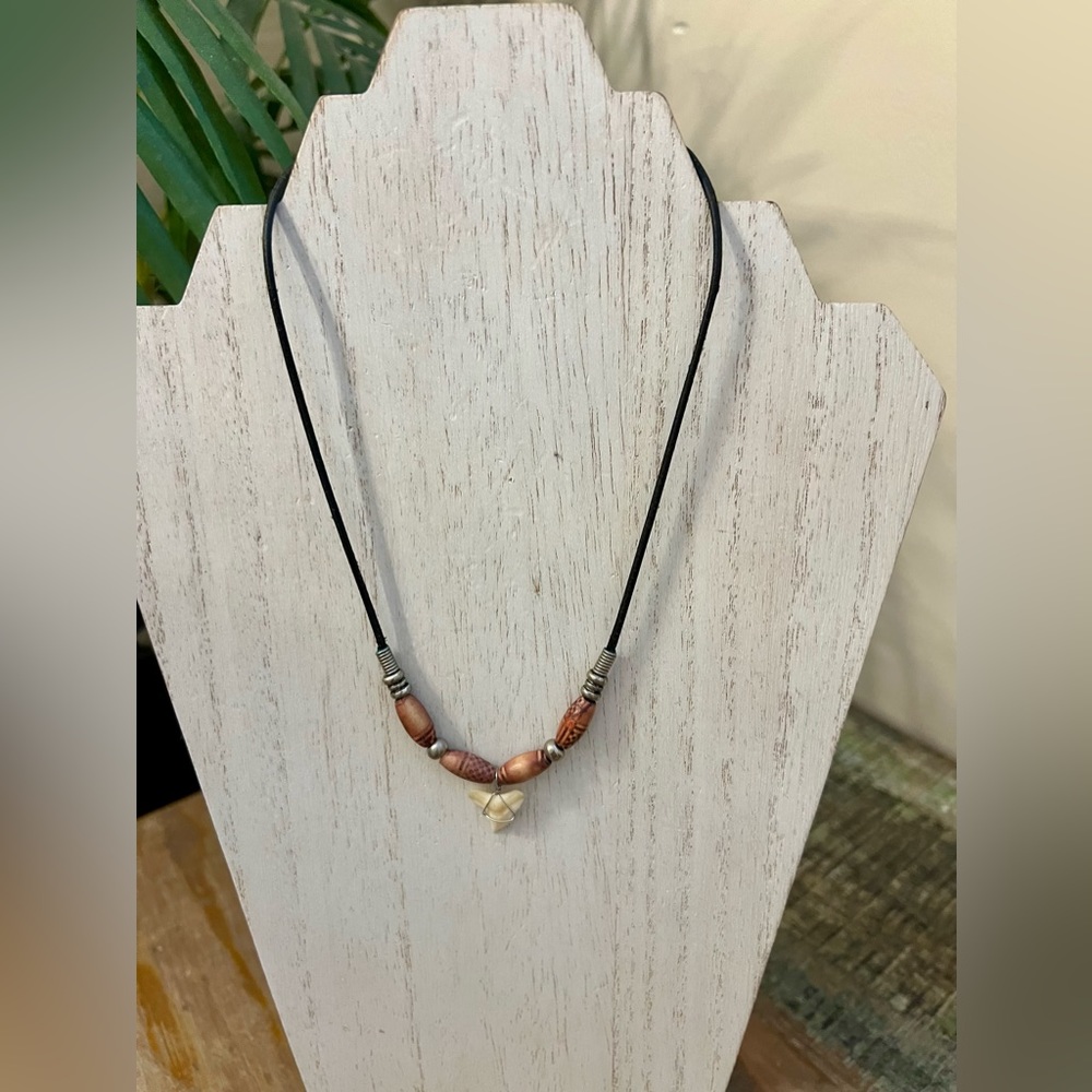 Shark tooth with brown bead necklace on black cord. Necklace measures 17 inches